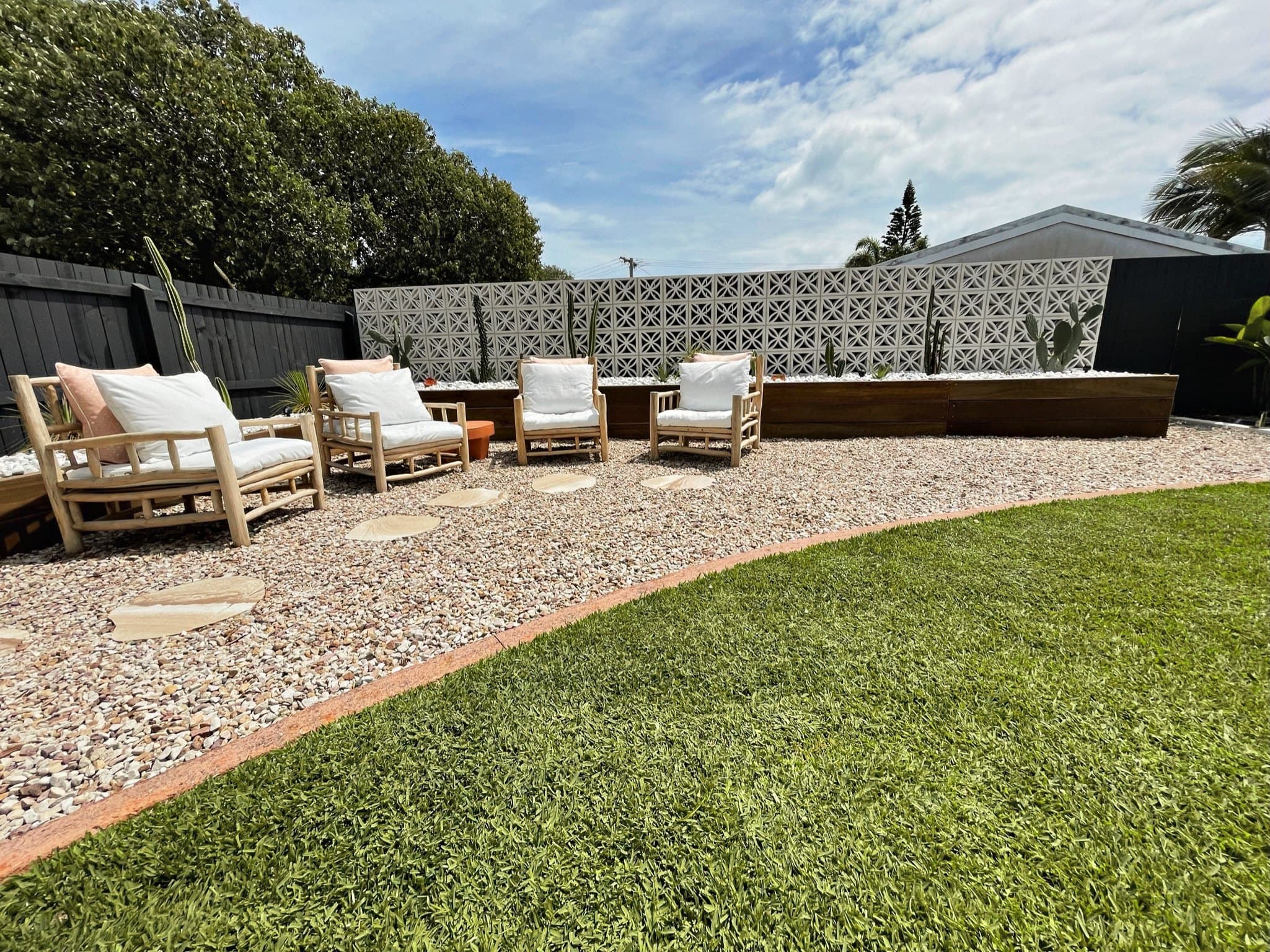Completed courtyard makeover with gravel terrace, lawn and outdoor seating