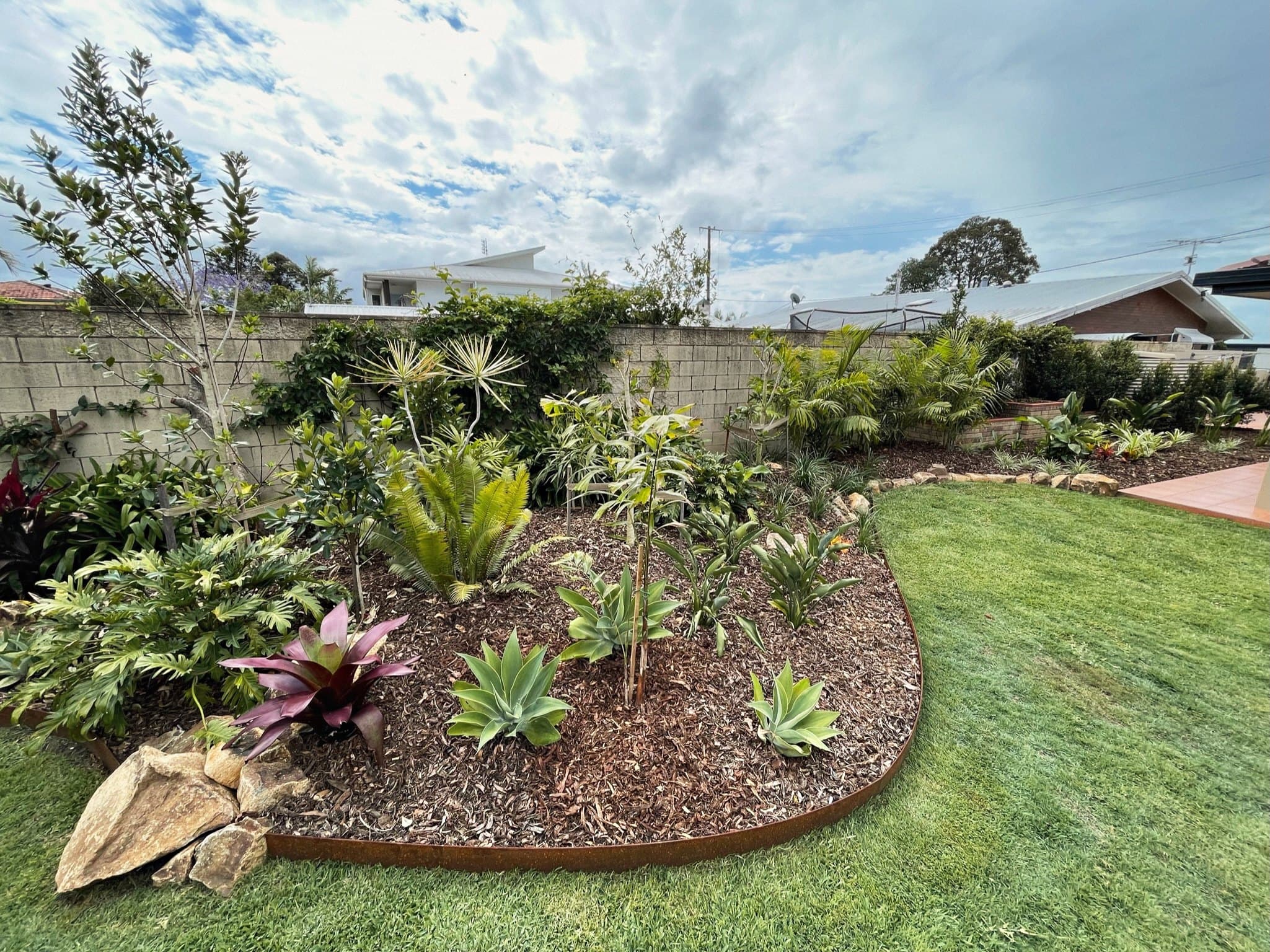 Layered native planting bed installed by Loving Your Garden