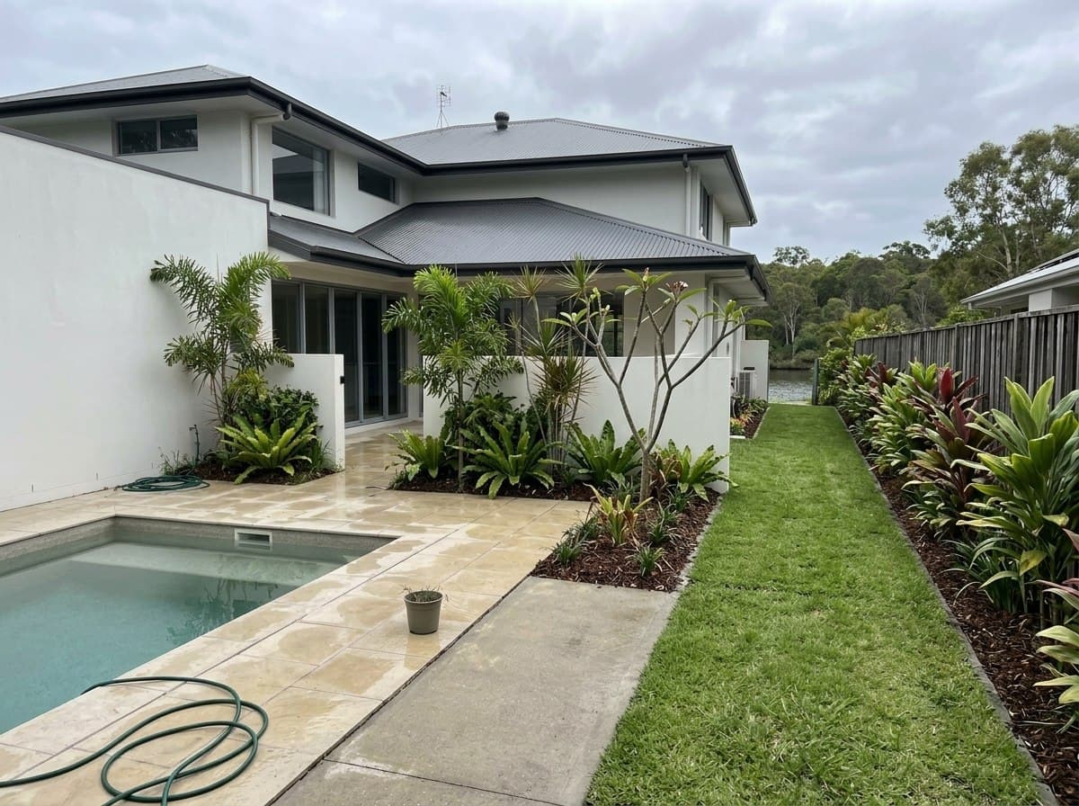 The same Noosaville courtyard with lush tropical screening and fresh lawn for guests